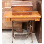 An oak treadle Singer sewing machine; together with another sewing machine, both early 20th Century