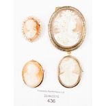 An oval cameo brooch in 9ct gold brooch, two others smaller and another in white metal mount