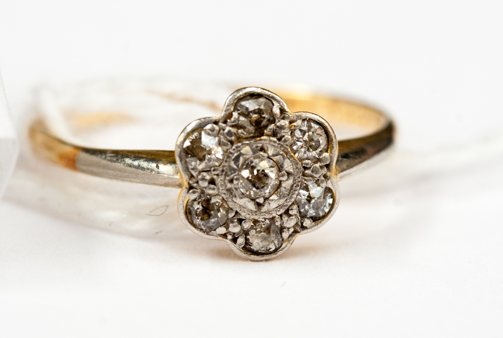**RE-OFFER MAY 100/150**An 18ct gold and platinum petal diamond ring (seven diamonds)
