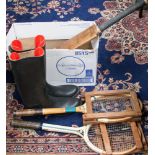 A collection of vintage sports equipment to include tennis rackets and presses, cricket bat, riding