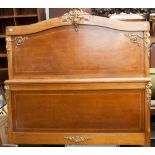 A French style early 20th century bedstead, with headboard and foreboard, each applied with gilt