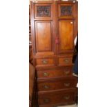 A late Victorian mahogany wardrobe centre, fitted with two doors, the base two short over three