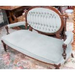 A mid Victorian walnut settee, originally part of a Salon set, deep buttoned back and upholstered