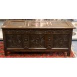 A late 17th Century oak chest, with carved front, panelled top and panelled sides, fitted with a