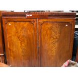 An early 19th century mahogany side cabinet, raised on bracket feet