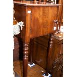 An early 19th century mahogany pot cupboard, fitted with a single door, raised on turned tapering