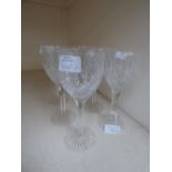 A Stuart crystal set of cut glass wine glasses with hobnail cut bowls, raised on blade cut stems,
