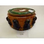 A pottery stand (small) moulded with Buddha yellow/green/blue glaze