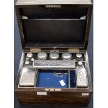 A Coromandel travelling dressing table box, enclosing jars and boxes with silver on copper tops