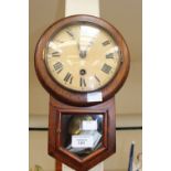 A late Victorian small drop case wall clock, printed dial with Roman numerals, with pendulum and