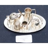 A London silver miniature tray, tea pot, coffee pot, jug and sugar bowl together with a silver