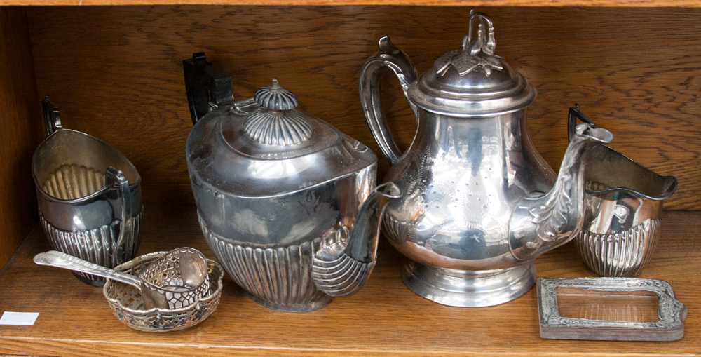 A three piece tea service EPBM, silver plated teapot, silver frame, EPNS napkin ring and pierced