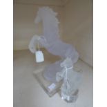 A resin Reaming horse on perspex stand and a smaller version in glass by Nachtmann, Germany