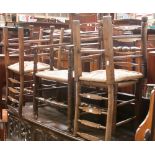 A set of five early 19th century ash and elm rush seated ladder back chairs,