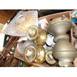 A collection of brass oil lamps and shades