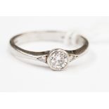 A platinum and diamond solitaire ring, the round cut brilliant stone approx 0.