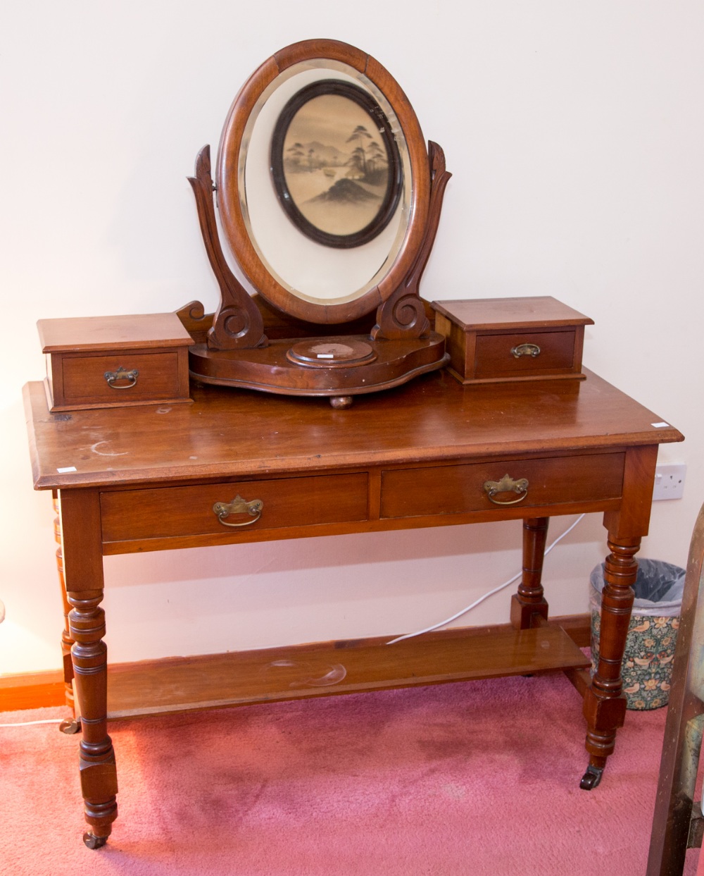 A late Victorian mahogany dressing table, fitted with two short drawers with two further drawers to