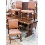 A George V oak dining suite, comprising four side chairs and a dining table, in the Jacobean style