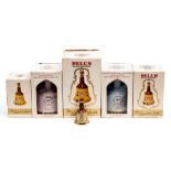 A collection of Bells whiskey in ceramic decanters.