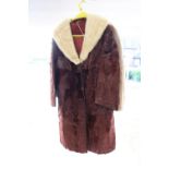 A 1950s ladies coat with Mink collar and leather trim, henna colour and a 1970s faux fur jacket