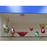 A collection of assorted glass, including red glass bowl, wine glass, decanter, claret jug, a bell,