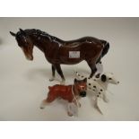 A Beswick horse together with two further dog figures