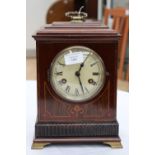 An Edwardian mahogany and inlaid bracket clock, printed dial with Roman numerals, brass handle and