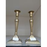 A pair of George III brass candlesticks