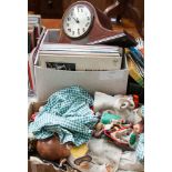 Two boxes of assorted items including a dome top mantel clock, records, dolls, etc