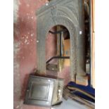 A Victorian cast metal fireplace surround, fender and wooden coal scuttle