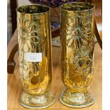 A pair of Trench Art brass shell vases with repousse floral decoration, dated Jan 1917 and July