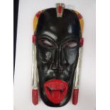 An early 20th Century walnut carved tribal art wall kissing mask.