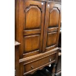 An Inglesants oak side cabinet, fitted with two panelled doors opening to reveal a fitted interior,