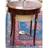 A George III mahogany oval sewing table, raised on square legs, with splaying terminals