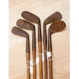 Five vintage iron golf clubs with hickory shafts, one stamped 'Jas. Thomson, St. Andrews Special'