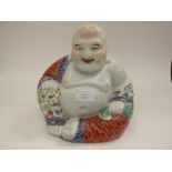 An oriental porcelain figure of a seated Buddha