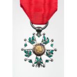 A miniature Legion d'Honneur decoration, enamelled silver on a red ribbon