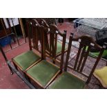 A set of four Edwardian oak side chairs