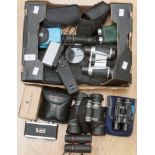 A collection of assorted binoculars, mostly modern,