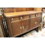 A 1930's oak sideboard with two drawers above two cupboards.