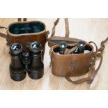 A pair of military Colmont binoculars with leather coated sides,