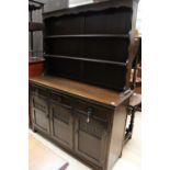 A late 20th century 17th century style oak dresser with rack, the rack fitted with two shelves,