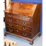 A George III mahogany bureau, circa 1770, the fall front opening to reveal drawers and pigeon holes,