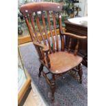 A 19th century Windsor beech and elm saddle seated armchair,