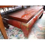 An Oriental red lacquer low table,