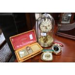 A timepiece under glass dome and three travel clocks (4)