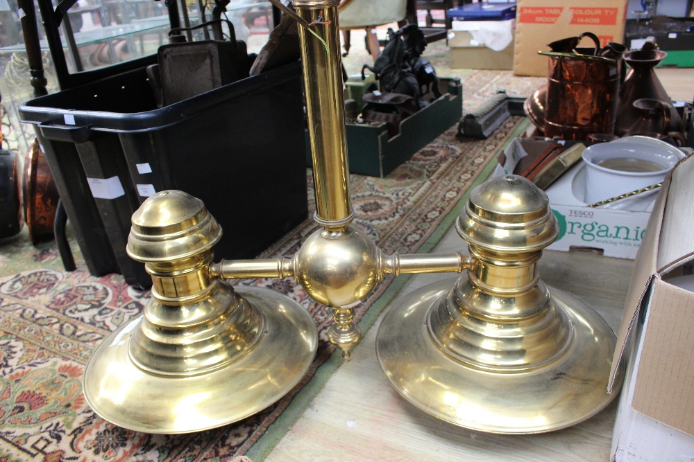 A large brass chandelier with central column and two large diffusing lights in an