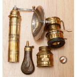 A miners brass helmet lamp, a brass grinder, a copper and brass gunpowder flask,