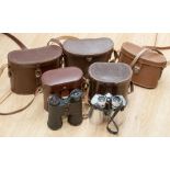 A collection of five various brown leather cased binoculars, including Wray, Boss,