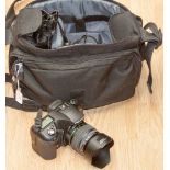 A camera carrying case containing a Pentax K10 camera, plus flash light,